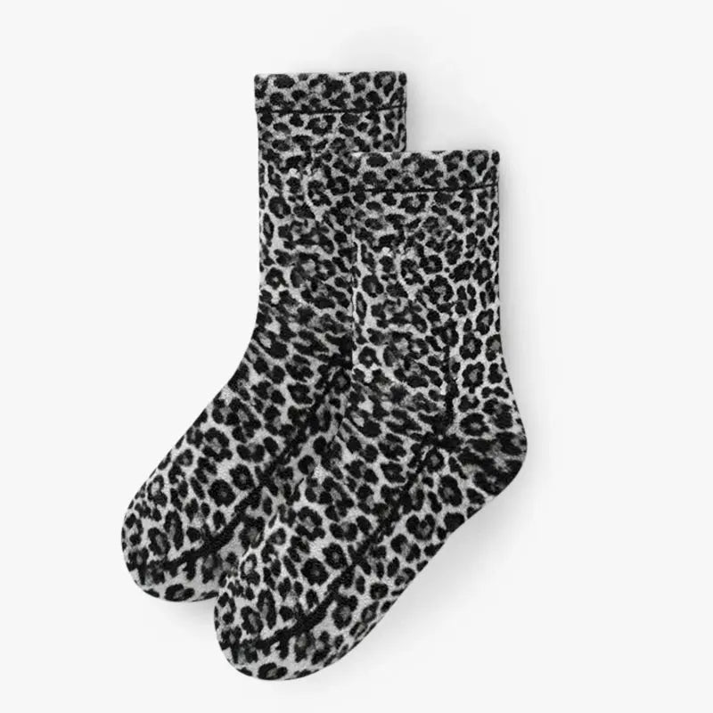 Pair of snow leopard fleece crew socks, black-and-white spotted pattern.