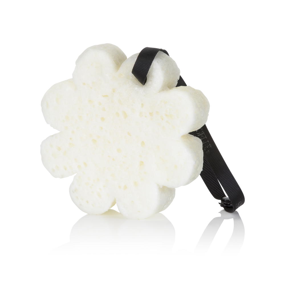 White flower body buffer sponge with black ribbon strap
