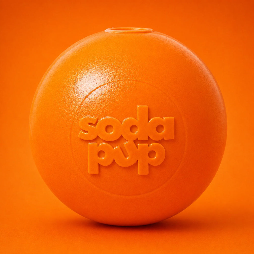 Orange rubber squeaky dog ball toy with soda pup logo