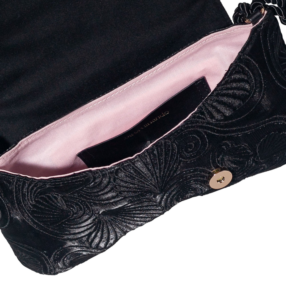 Close-up of black bag flap with starfish clasp, gold snap, and rose interior lining