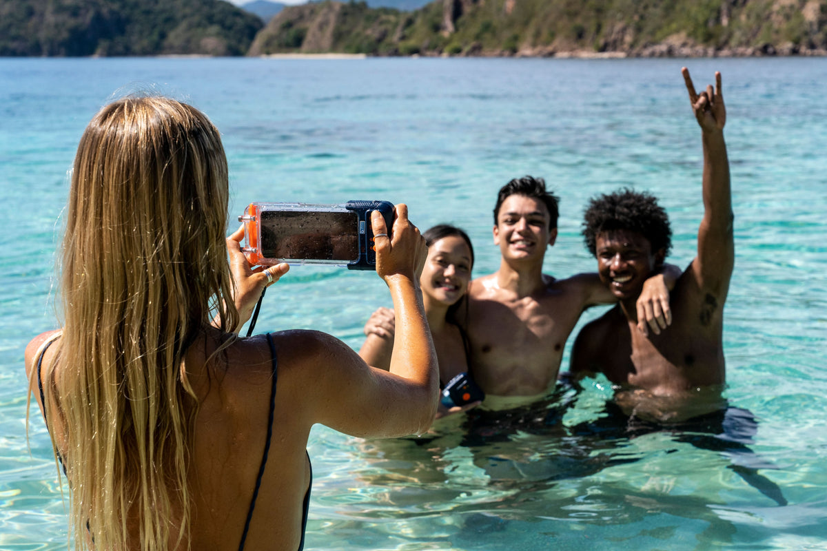 Waterproof phone case on a phone held above water during outdoor swimming