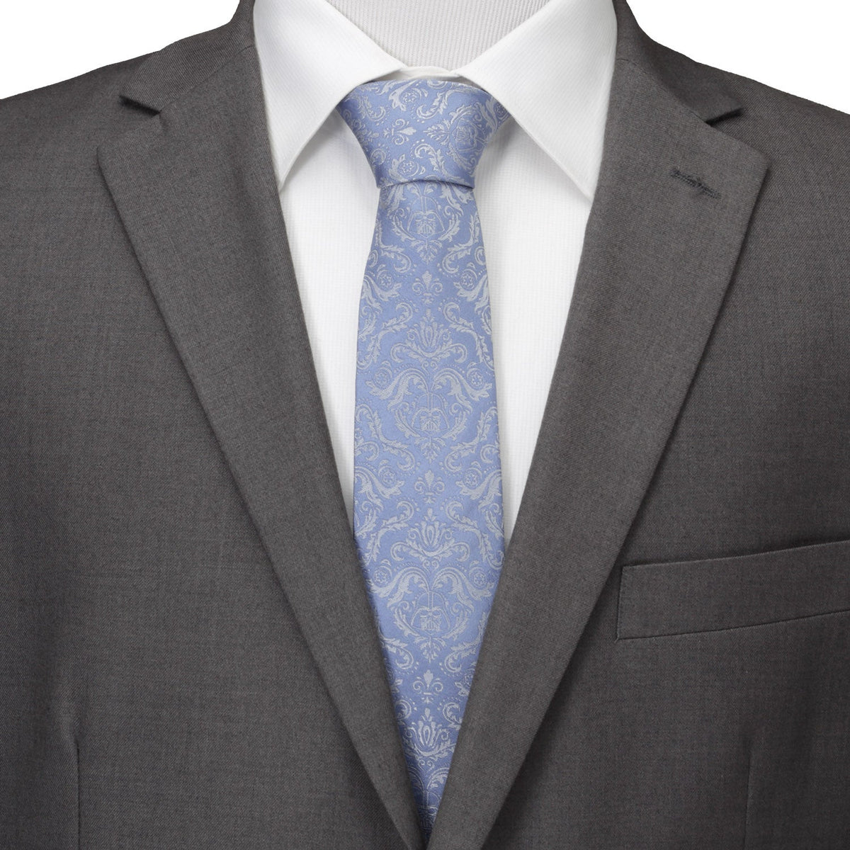 Blue damask necktie worn with a white dress shirt and gray suit jacket.