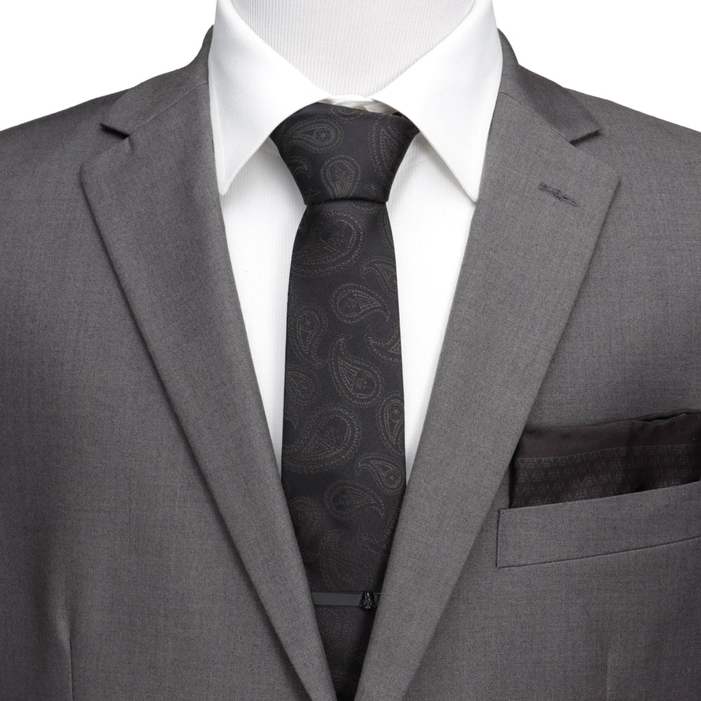 Black silk necktie with dark paisley pattern, centered on a dress shirt