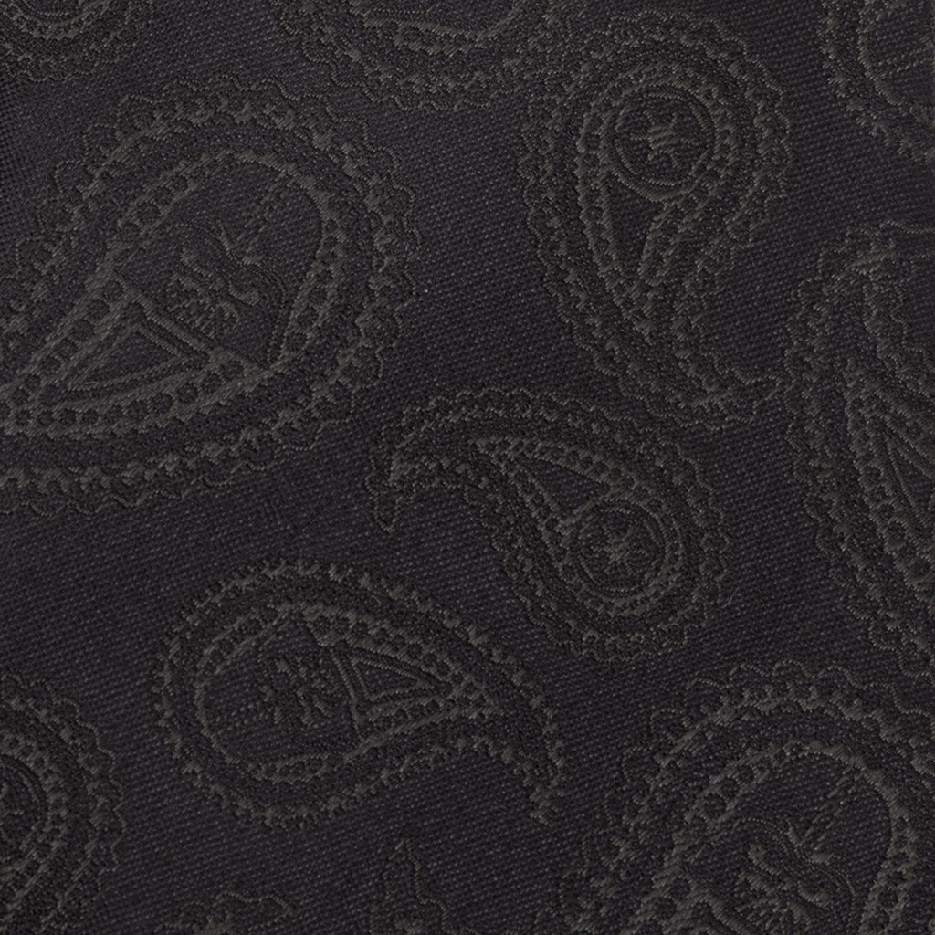 Black silk necktie close-up with dark paisley pattern texture