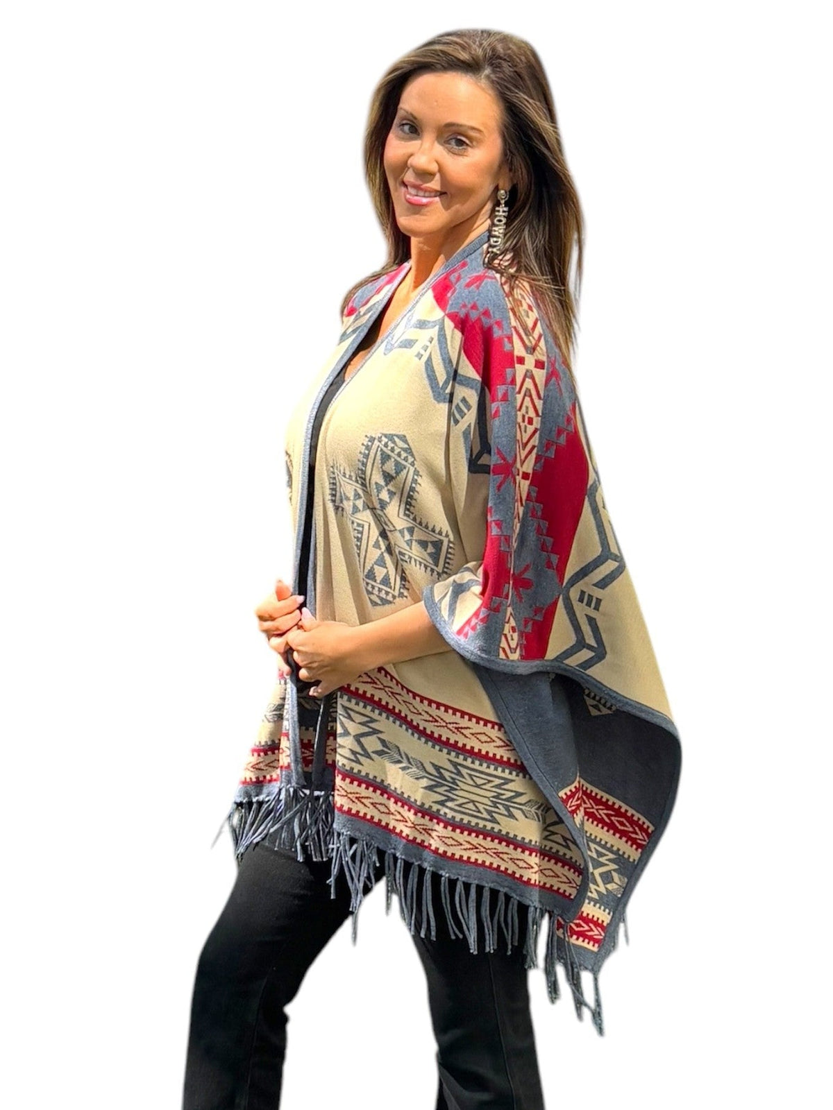 Reversible shawl wrap with multicolor geometric print and tassel fringe, draped at side