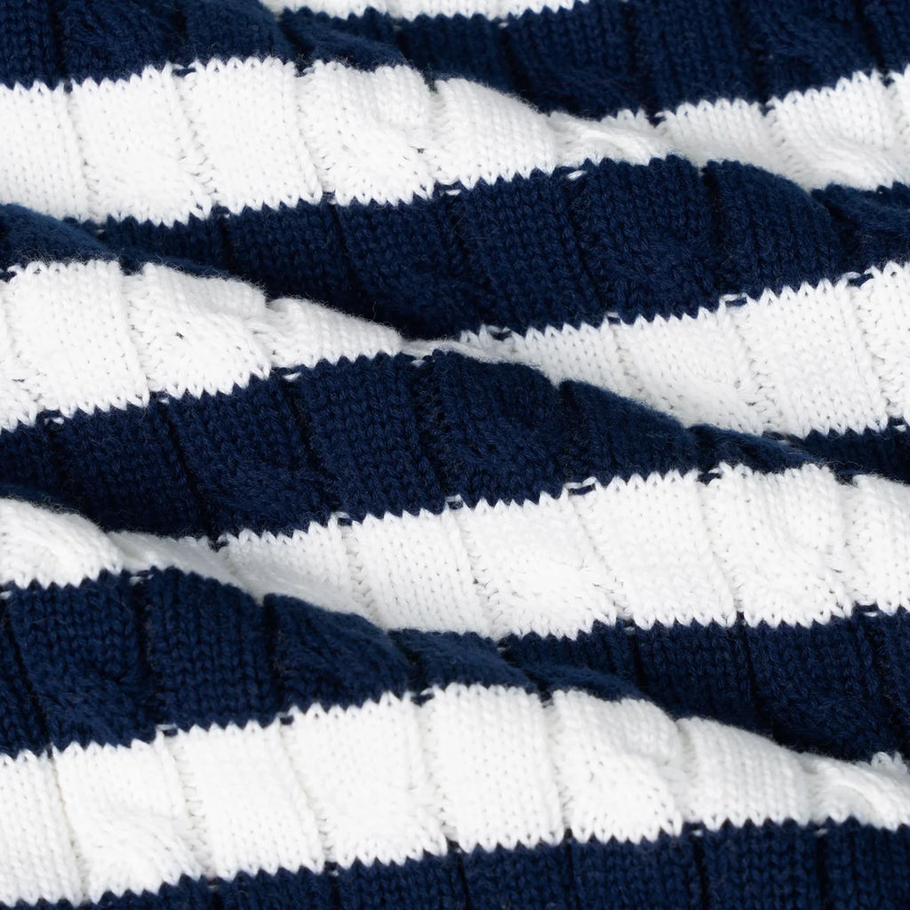 Striped knit sweater fabric close-up with navy-and-white raised stitch texture