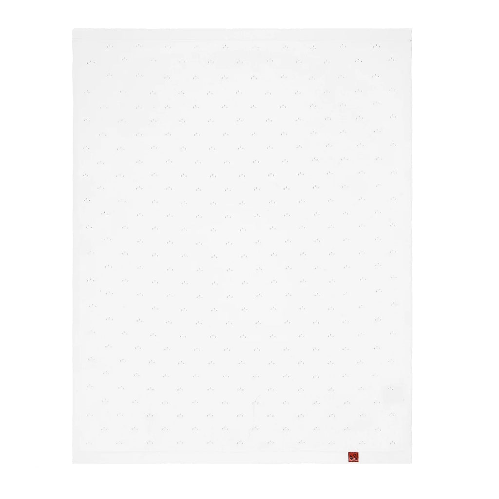 Pointelle baby knit blanket in white, flat square with tiny eyelet dots and small logo tag.