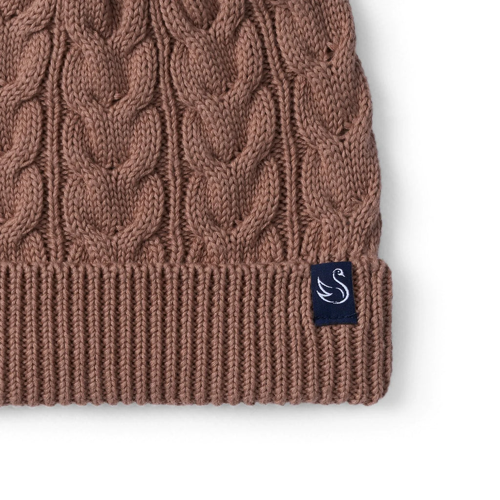 Mocha cable knit beanie cuff with side logo patch and cable knit texture close-up.