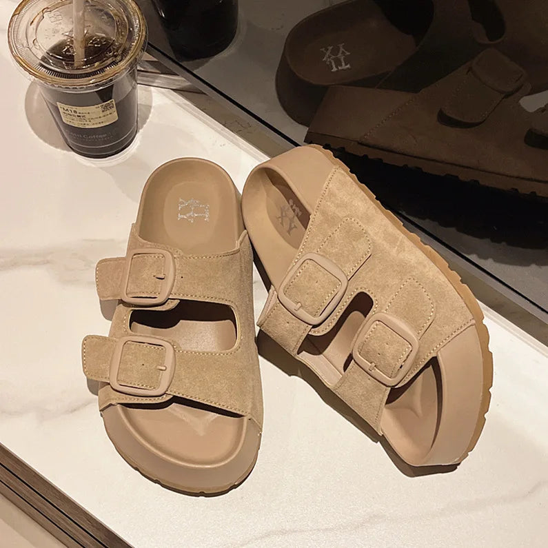 Beige suede slide sandals with two adjustable buckle straps and platform sole