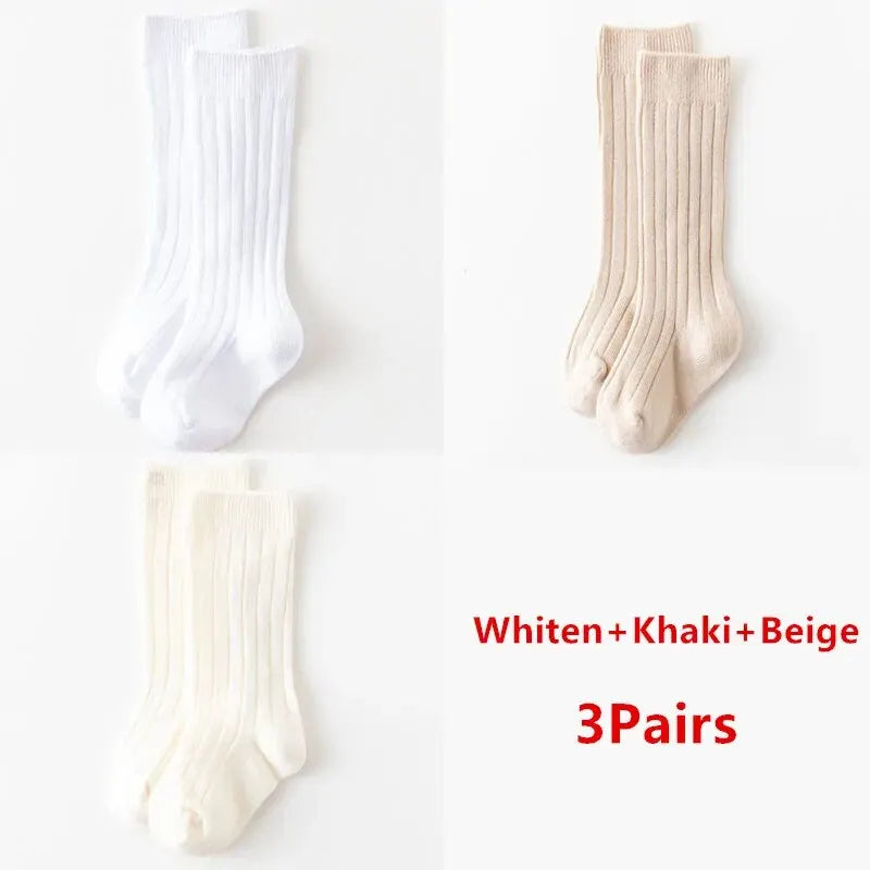 Kids knee-high striped socks in white, khaki, and beige, shown as three pairs.