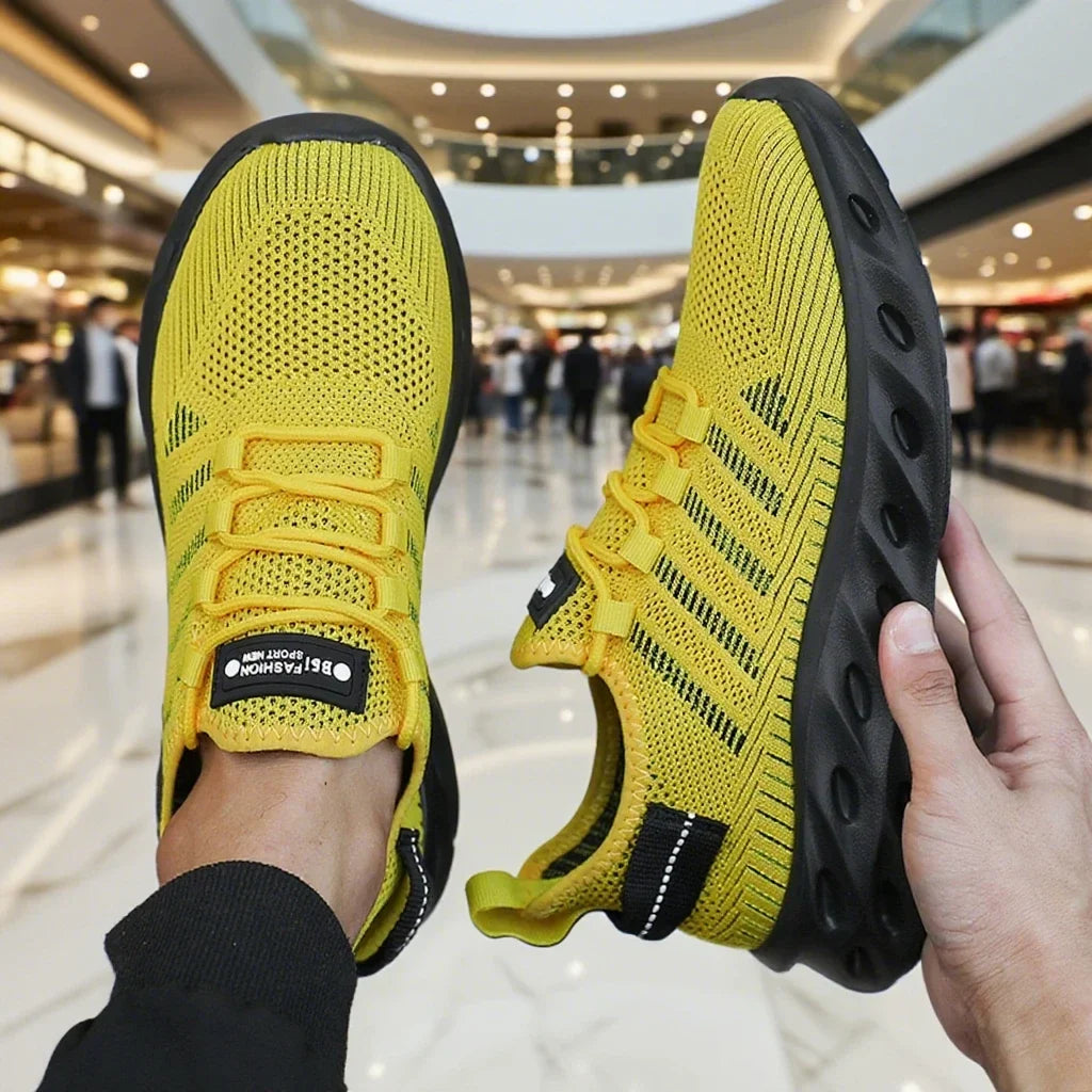 Yellow knit lace-up sports shoes with black thick sole, breathable perforated toe area