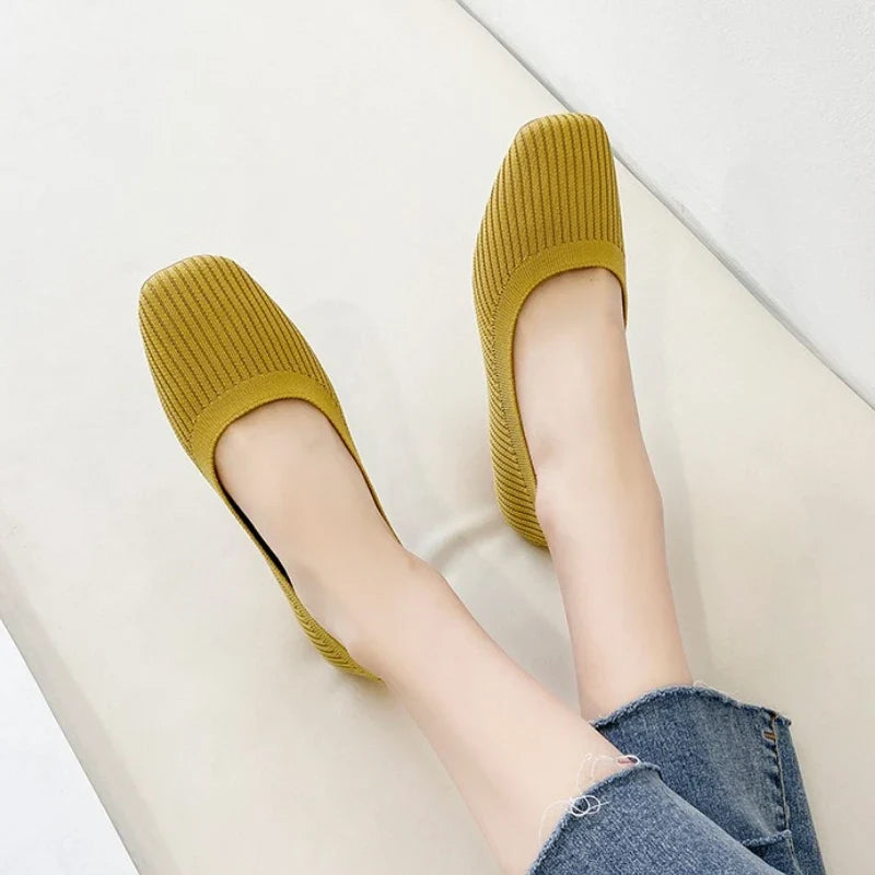 Women's yellow knit slip-on flats on feet, square toe, flat outsole