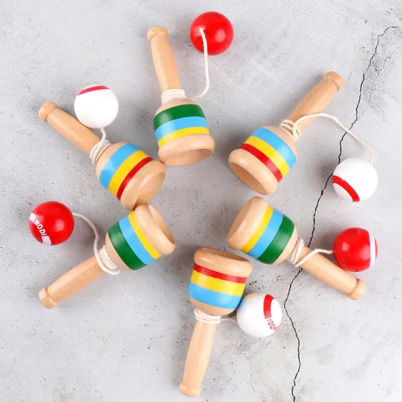 Set of wooden cup-and-ball skill cups with red balls and colored rings on handles