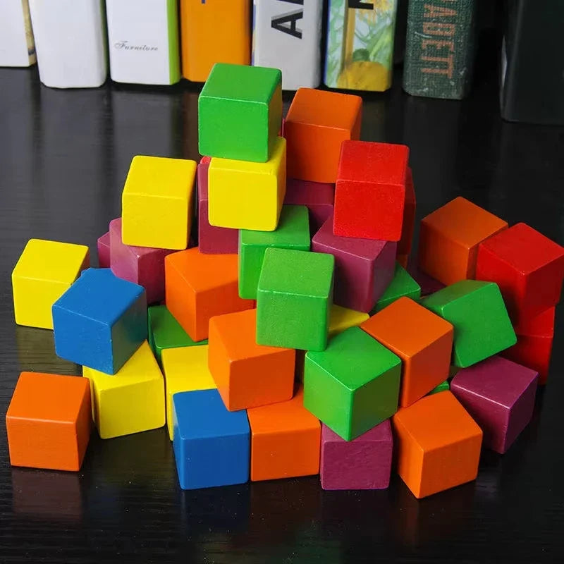 Assorted colorful wooden cube blocks piled together on a dark surface