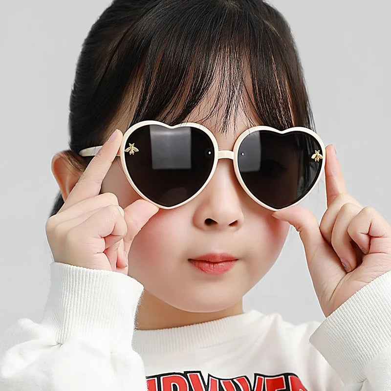 Kids heart sunglasses on child: white frames with dark lenses and star embellishments