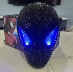 Blue electronic face mask with glowing blue eye panels and textured pattern