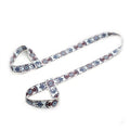 White yoga mat strap with blue and red patterned loops