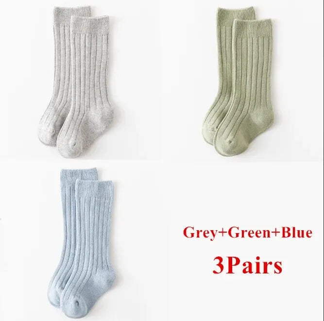Kids knee-high striped socks in gray, green, and light blue, shown as three pairs.