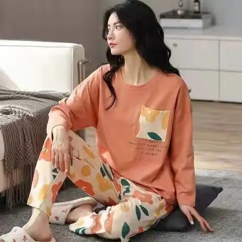 Women’s long-sleeve pajama set in rust orange with pocket graphic and floral pants