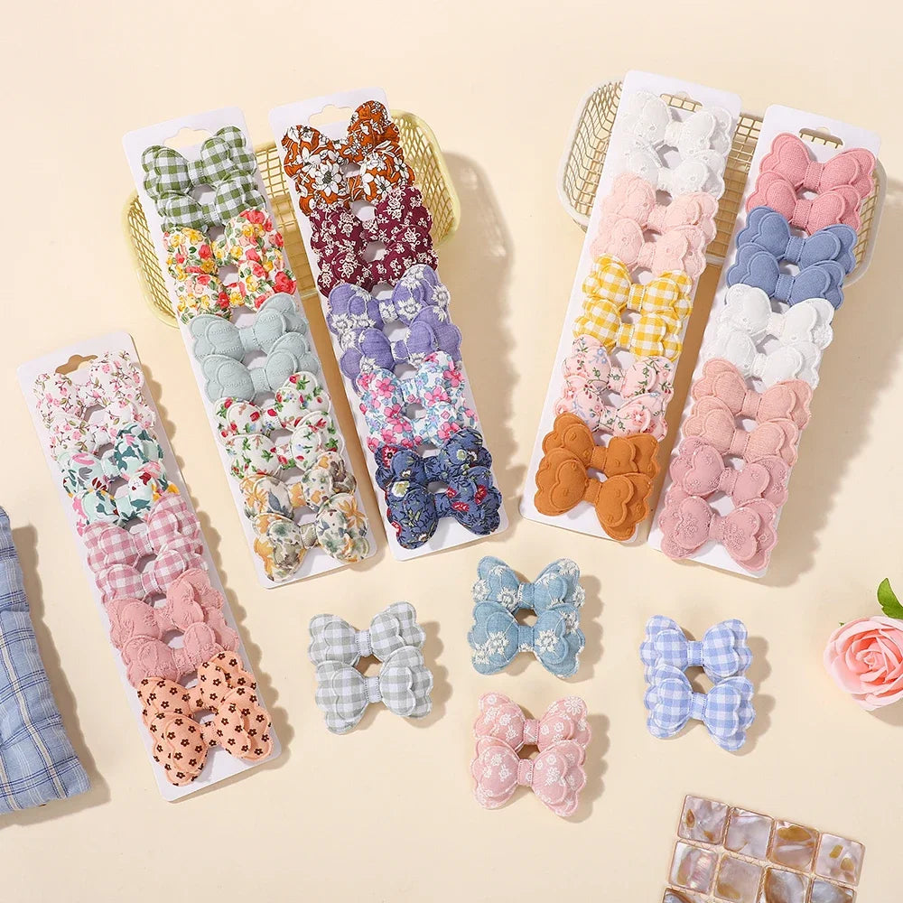 Assorted fabric bowknot hair clip set with multiple color patterns on hanging cards
