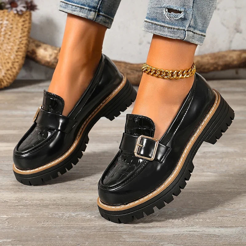 Black patent leather loafer pumps with round toe, buckle strap, thick platform sole
