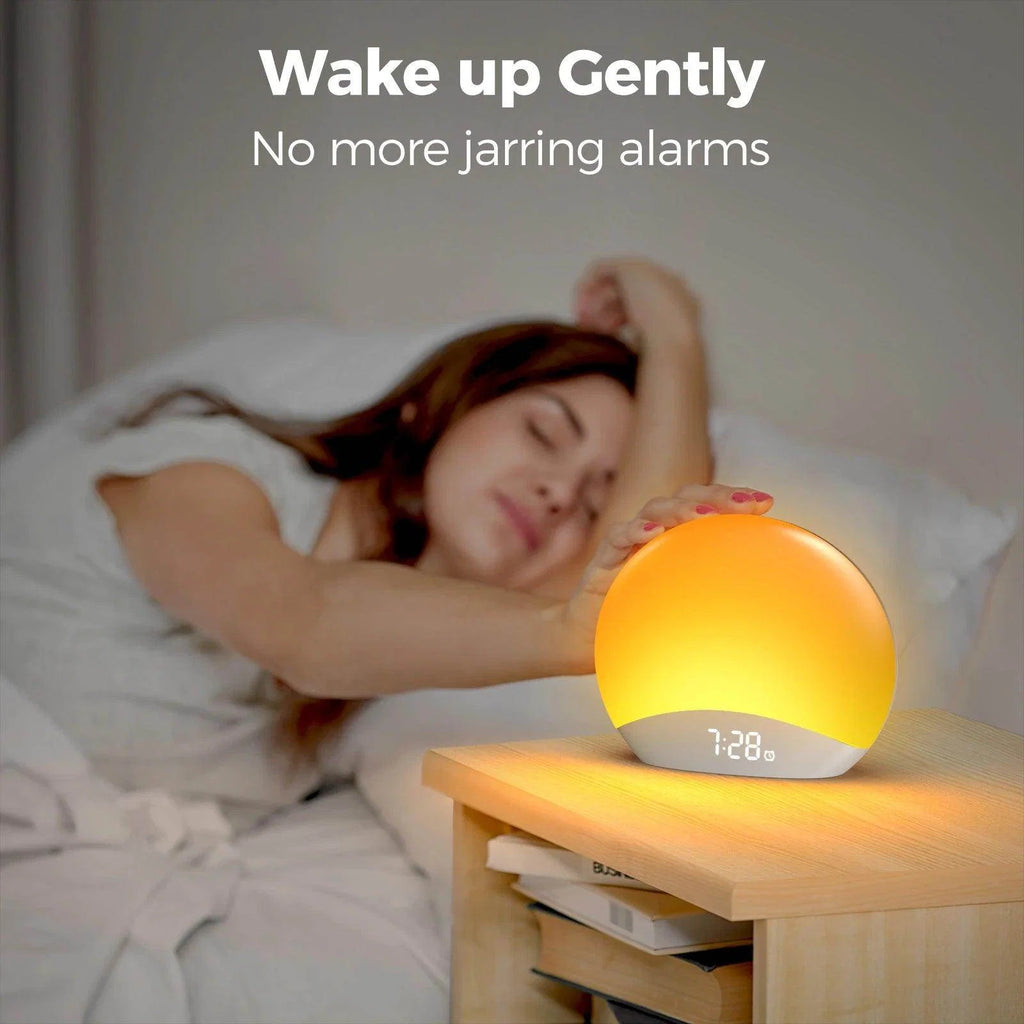 Sunrise alarm clock with warm orange bedside glow and digital time display