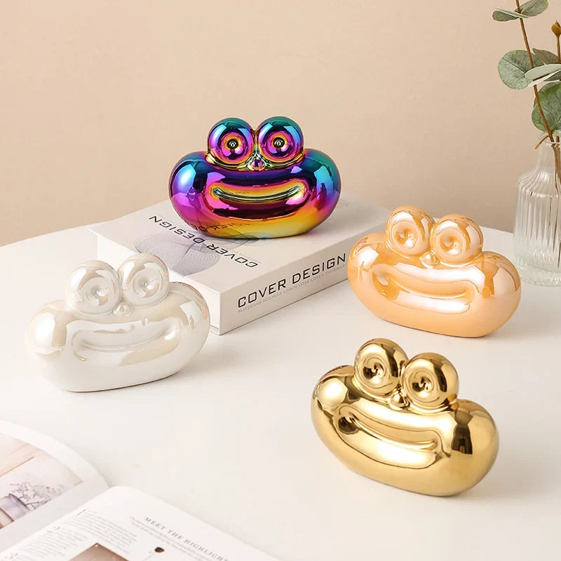 Saussage-shaped ceramic decorative ornaments in rainbow, cream, white, and gold