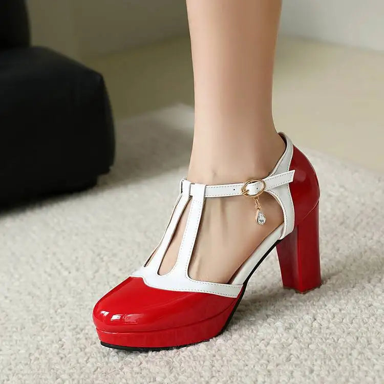 Red-and-white ankle Mary Jane heels with round toe, buckle charm, and square heel.