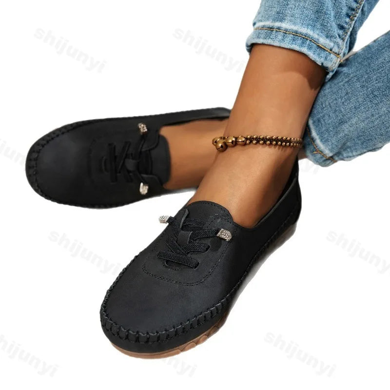 Women's lace-up loafers in black suede with round toe and stitched moccasin sole