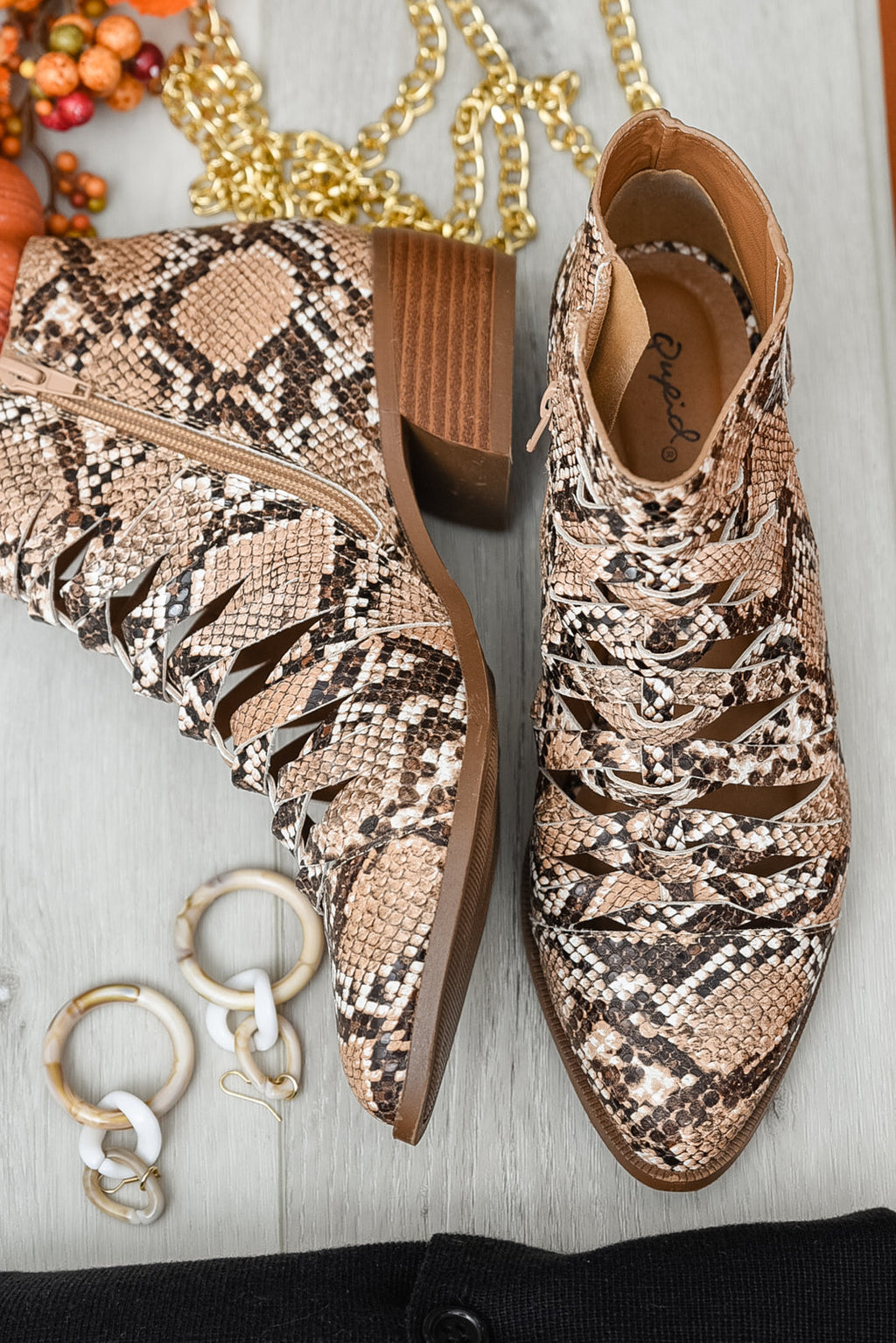 Pair of snakeskin ankle boots with lace-up front and brown block heel