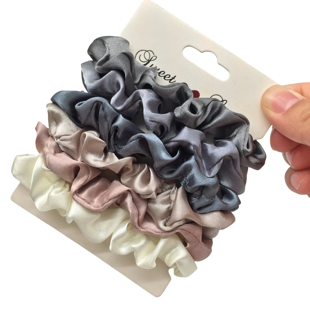 Silk satin scrunchies set in grey, blush pink, and white