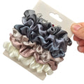 Silk satin scrunchies set in grey, blush pink, and white