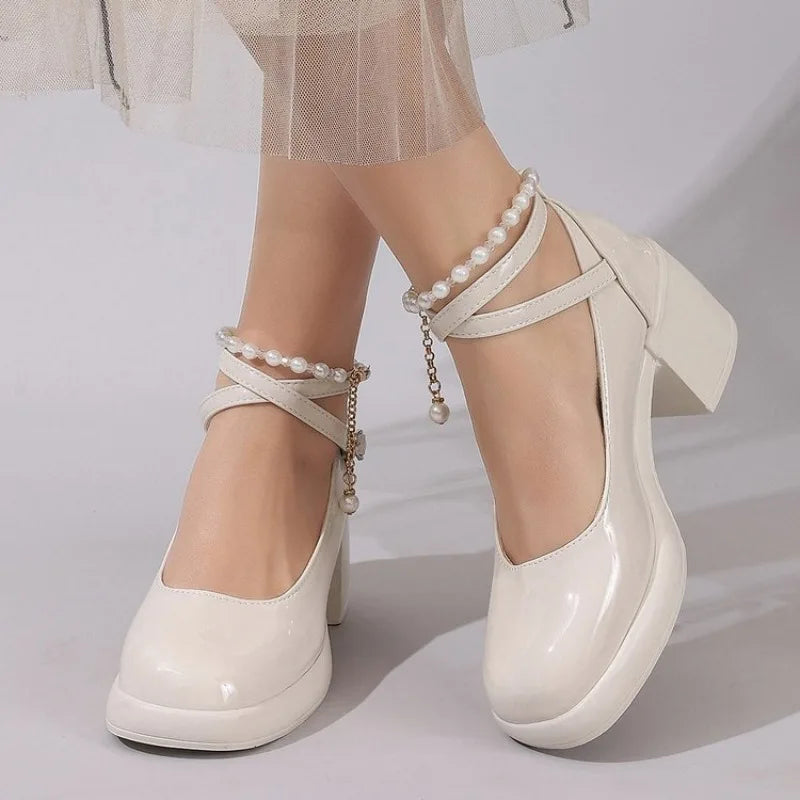 Off-white Mary Jane pumps with pearl cross straps and chunky block heel