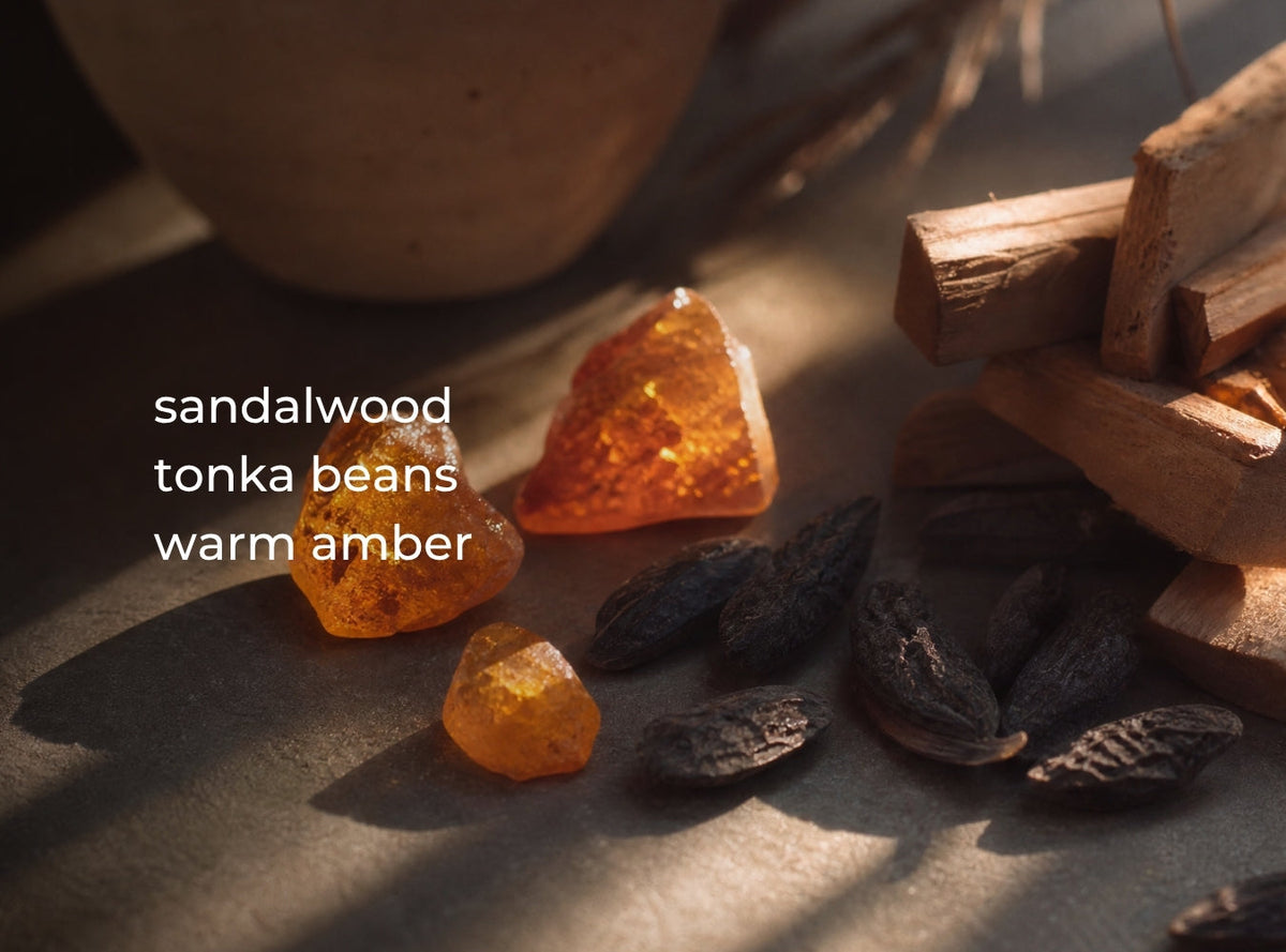 Three-wick candle with wax pieces and small wood chunks on a surface