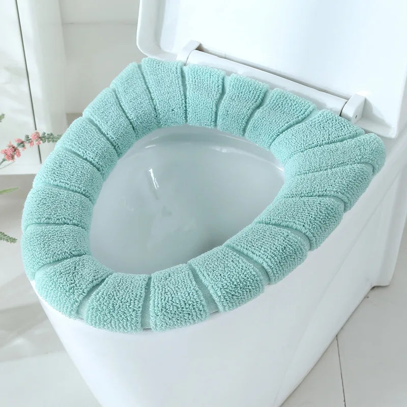 Mint green plush toilet seat cover mat fitted on a toilet seat