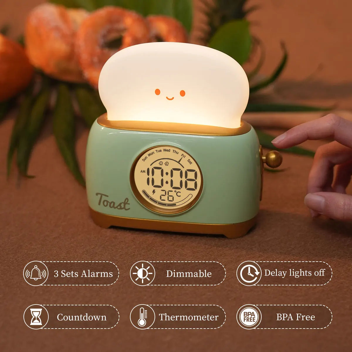 Green toaster-shaped kids alarm clock night light with glowing top and time display
