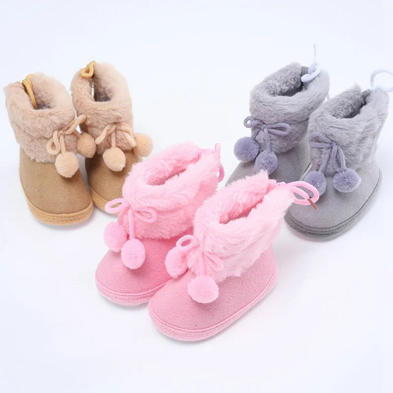 Baby winter snow booties with plush lining, pompom bows, and soft indoor sole; pink and gray