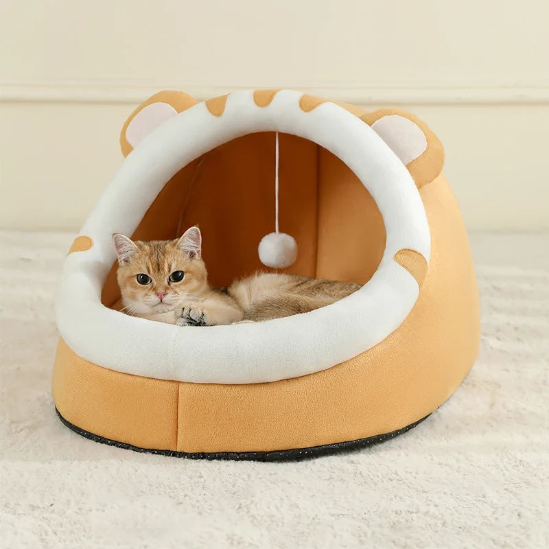 Yellow covered cat bed cave tent with round white opening rim and hanging pom-pom