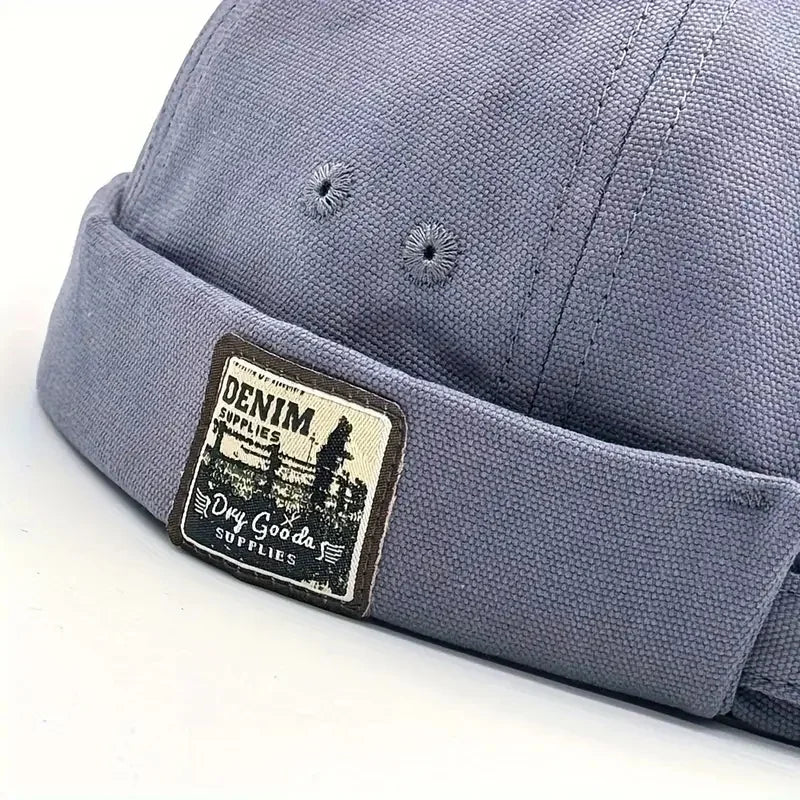 Blue fabric dome cap with adjustable strap and Denim Supplies logo patch