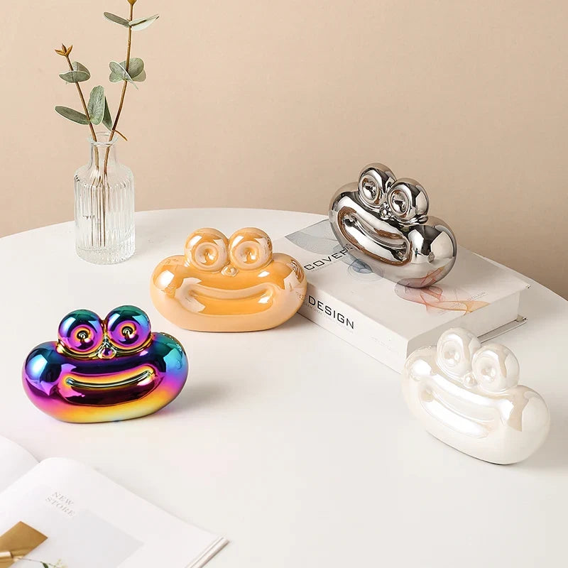 Saussage-shaped ceramic ornaments in rainbow, peach, silver, and white finishes