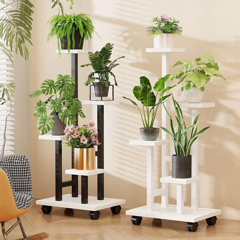 Rolling white multi-tier plant stand with potted plants on tiered shelves and caster wheels.