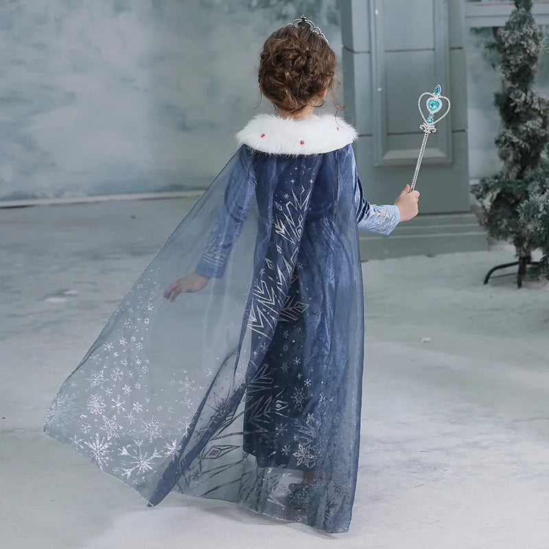 Girls long-sleeve blue princess dress with white fur collar, worn back view with overlay cape