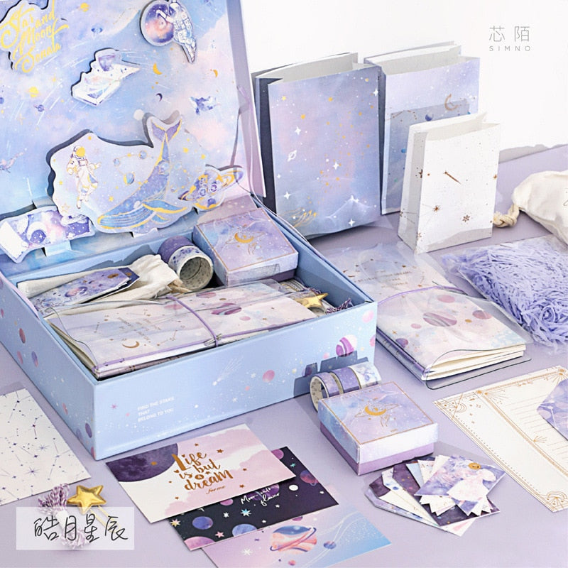 Blue stationery gift set tray with notebooks, cards, and decorative tape in boxes