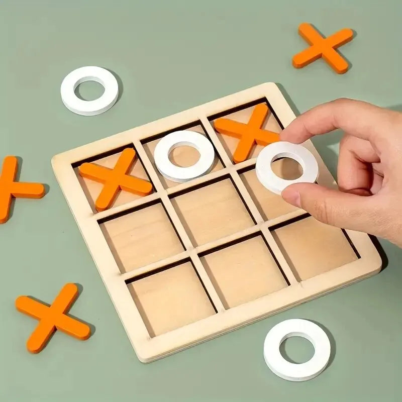 Wooden tic-tac-toe board with orange X and white O pieces, hand placing a piece