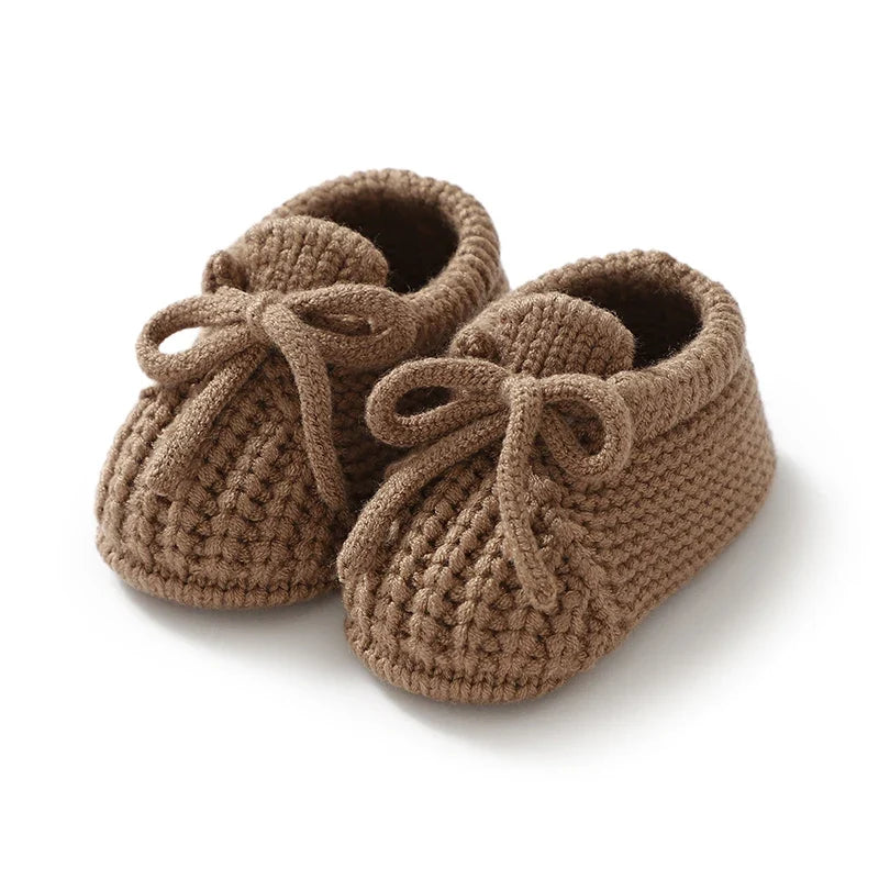 Brown knitted baby booties with soft lining and tie laces
