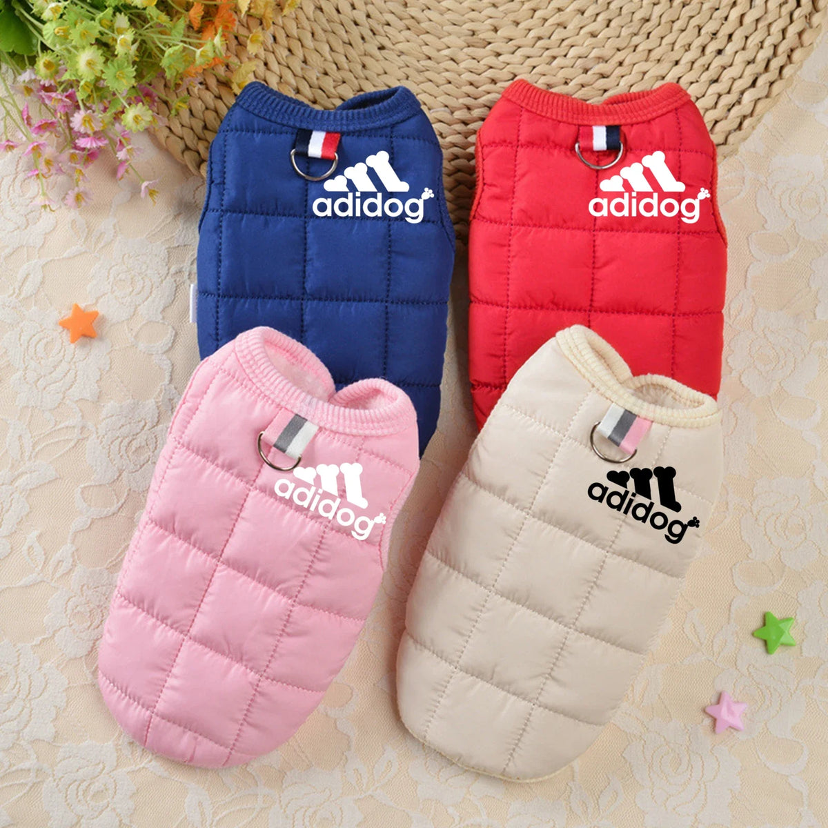 Four puffer dog hoodies in blue, red, pink, and cream with adidog logos