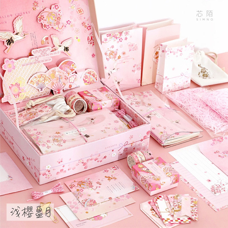 Pink stationery gift set with patterned cards, sticker pieces, and boxed accessories