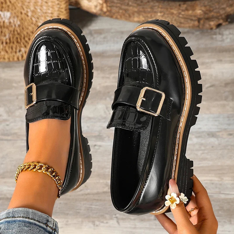 Black patent leather buckle loafers, glossy finish, thick lug sole, gold chain strap