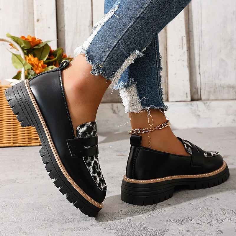 Women’s platform loafers, black with leopard-print accents, chunky sole, slip-on strap