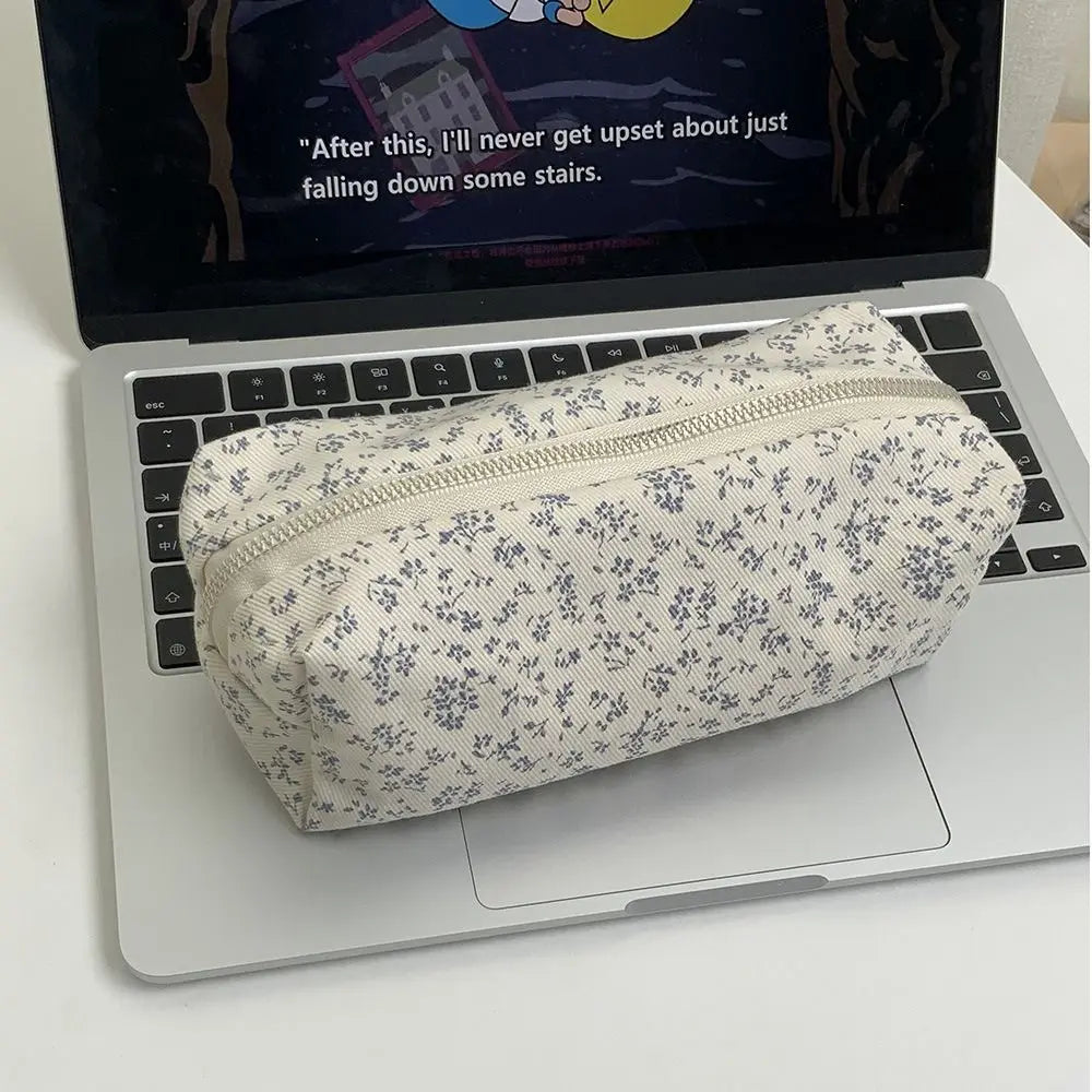Floral canvas pencil case with cream base and navy allover flower print